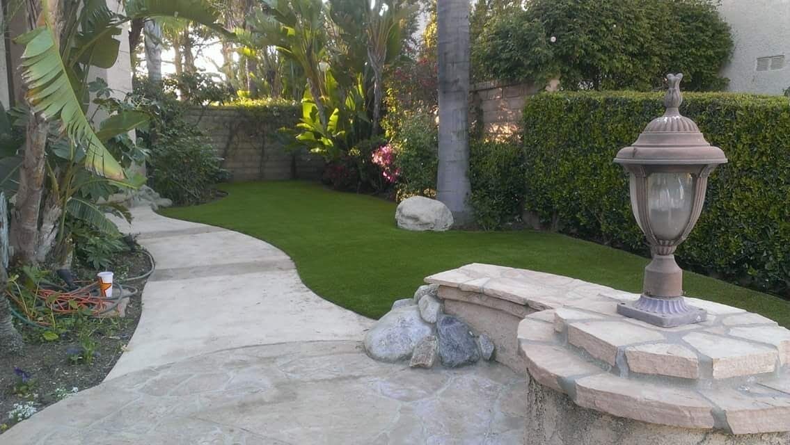 Terraced backyard lawn with retaining wall