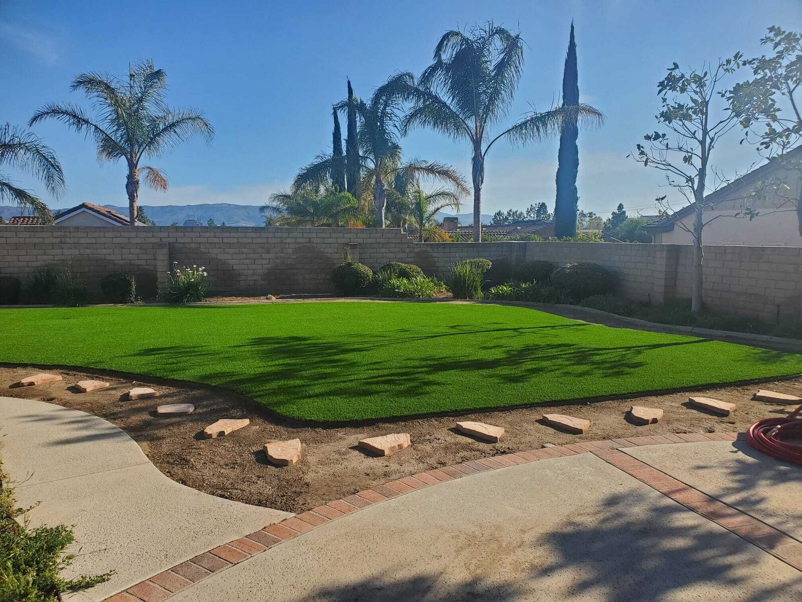 Backyard synthetic lawn installed by Greenview Turf