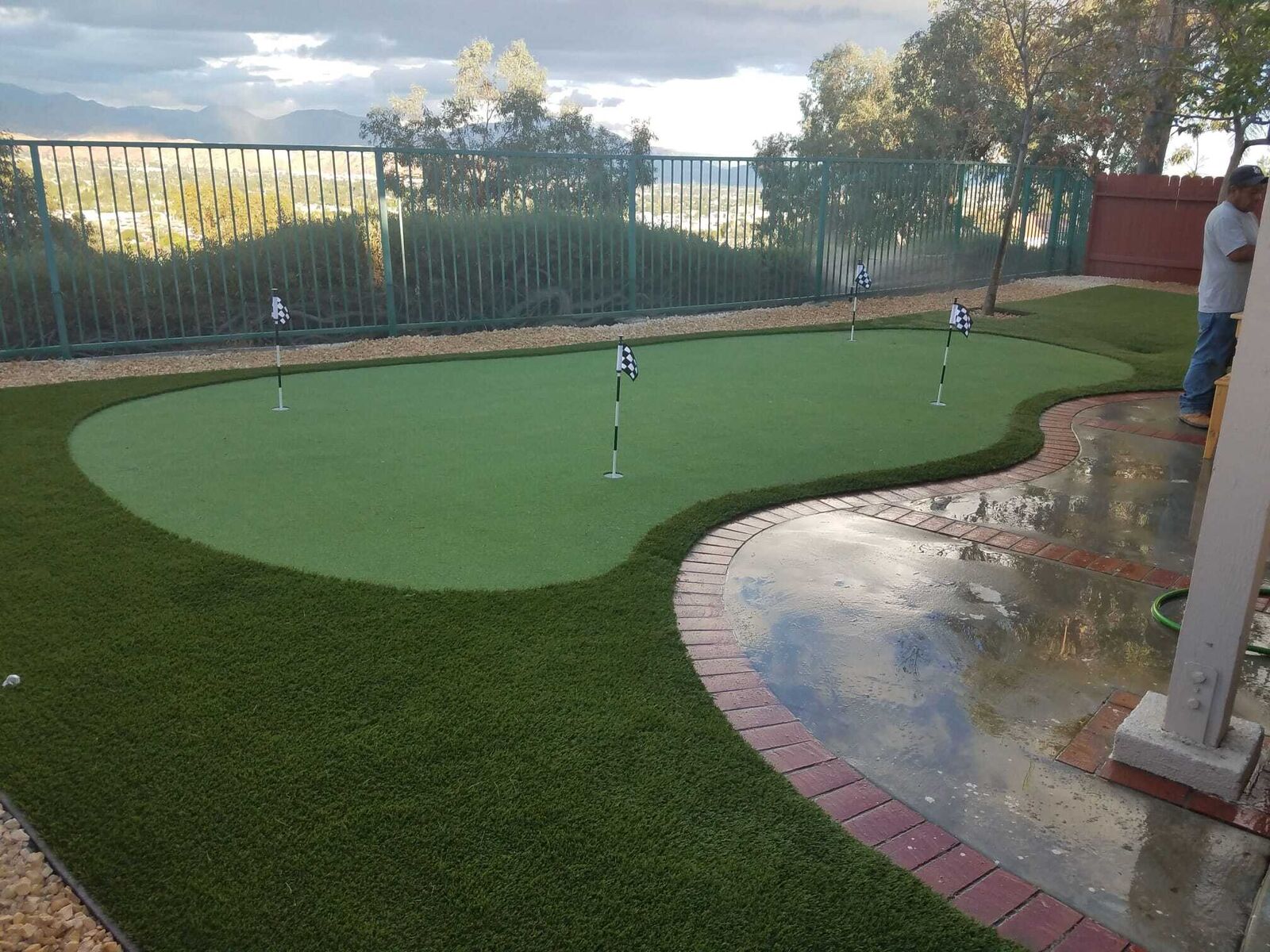 Crew finishing a backyard turf installation