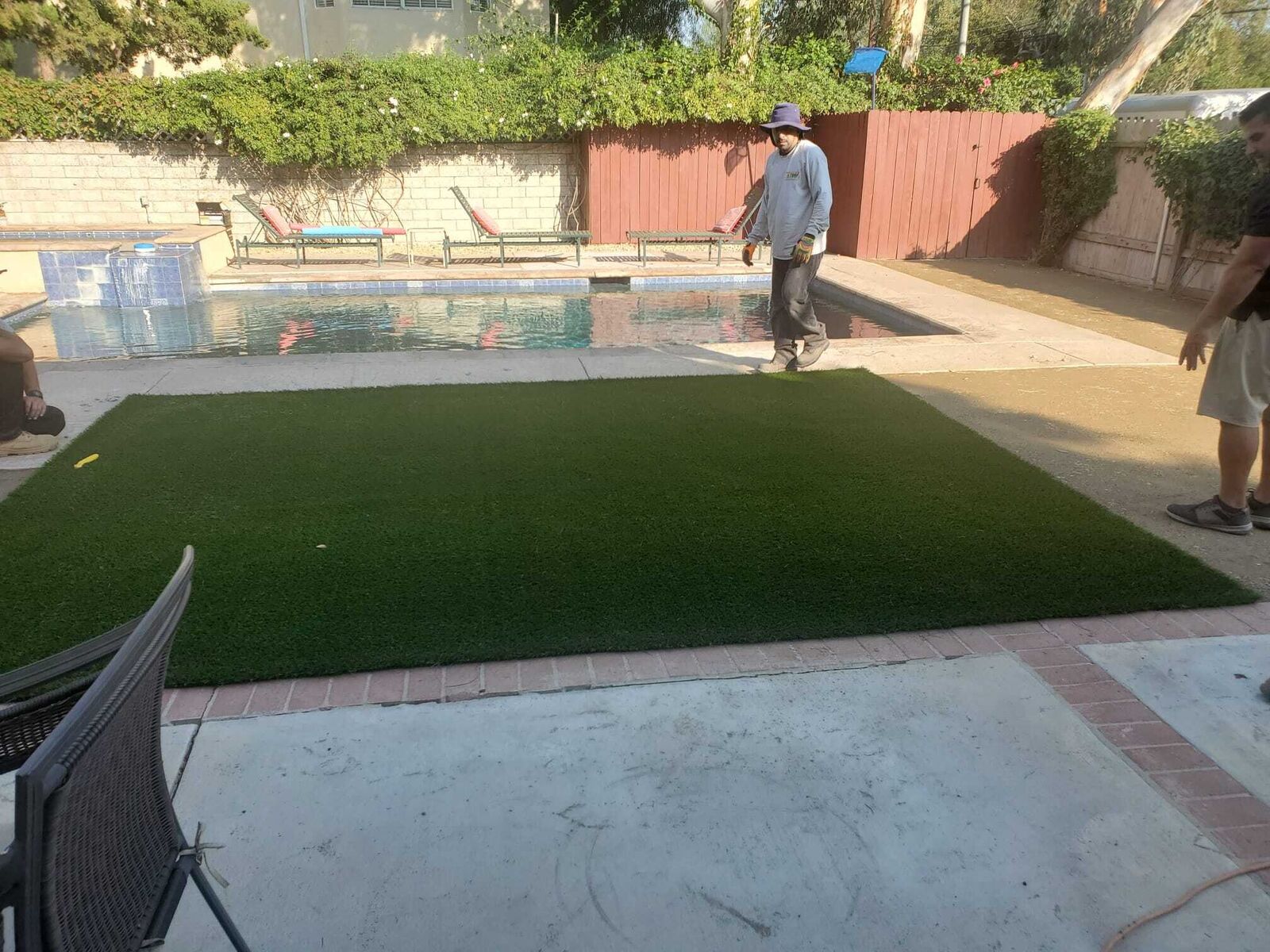 Synthetic lawn installed beside a backyard pool